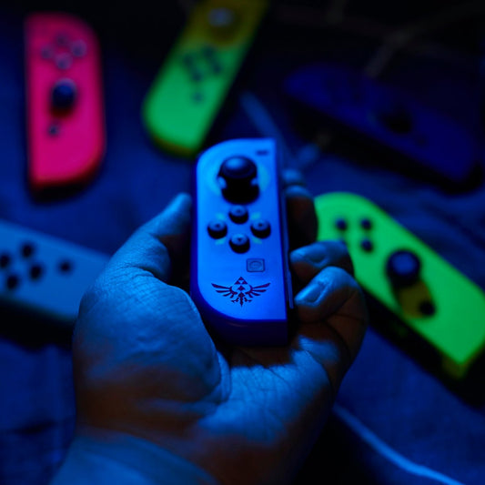 a person holding a nintendo wii controller in their hand